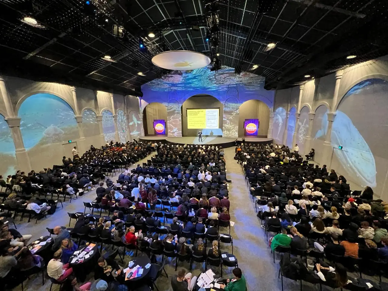 Cooper Chapman keynote at a large ocean-themed conference venue